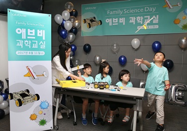 한국애브비 패밀리 사이언스 데이에 참가한 어린이들이 부모와 함께 만든 충전 비행기 구조와 원리를 체험하고, 자동차소프트웨어 코딩 후, 구동해 보고 있다.